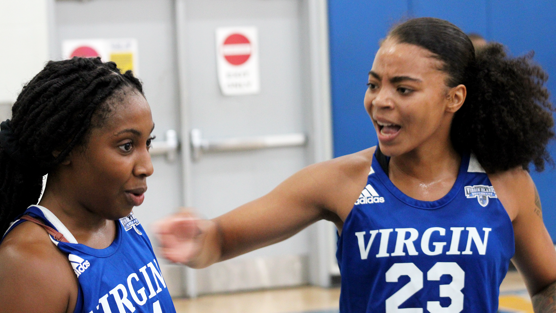 Kierra Neal (L) and Kaya Evans (R) celebrate the eventual win during a timeout.